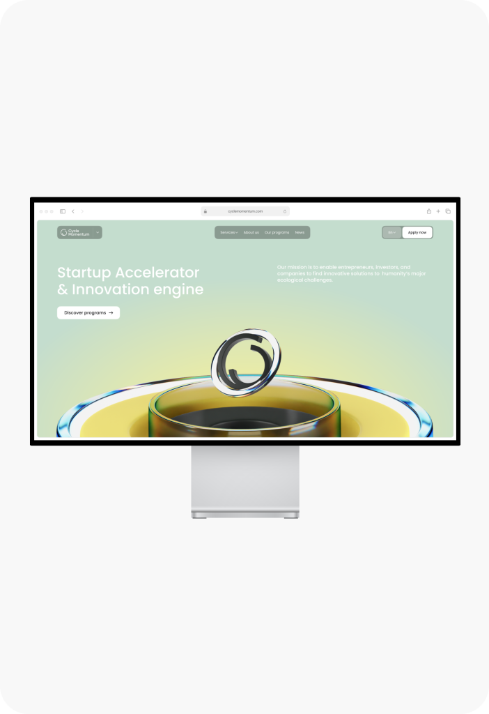 A monitor showcases a startup accelerator website crafted by Webgamma UX Agency, featuring a unique green and yellow liquid-themed design.