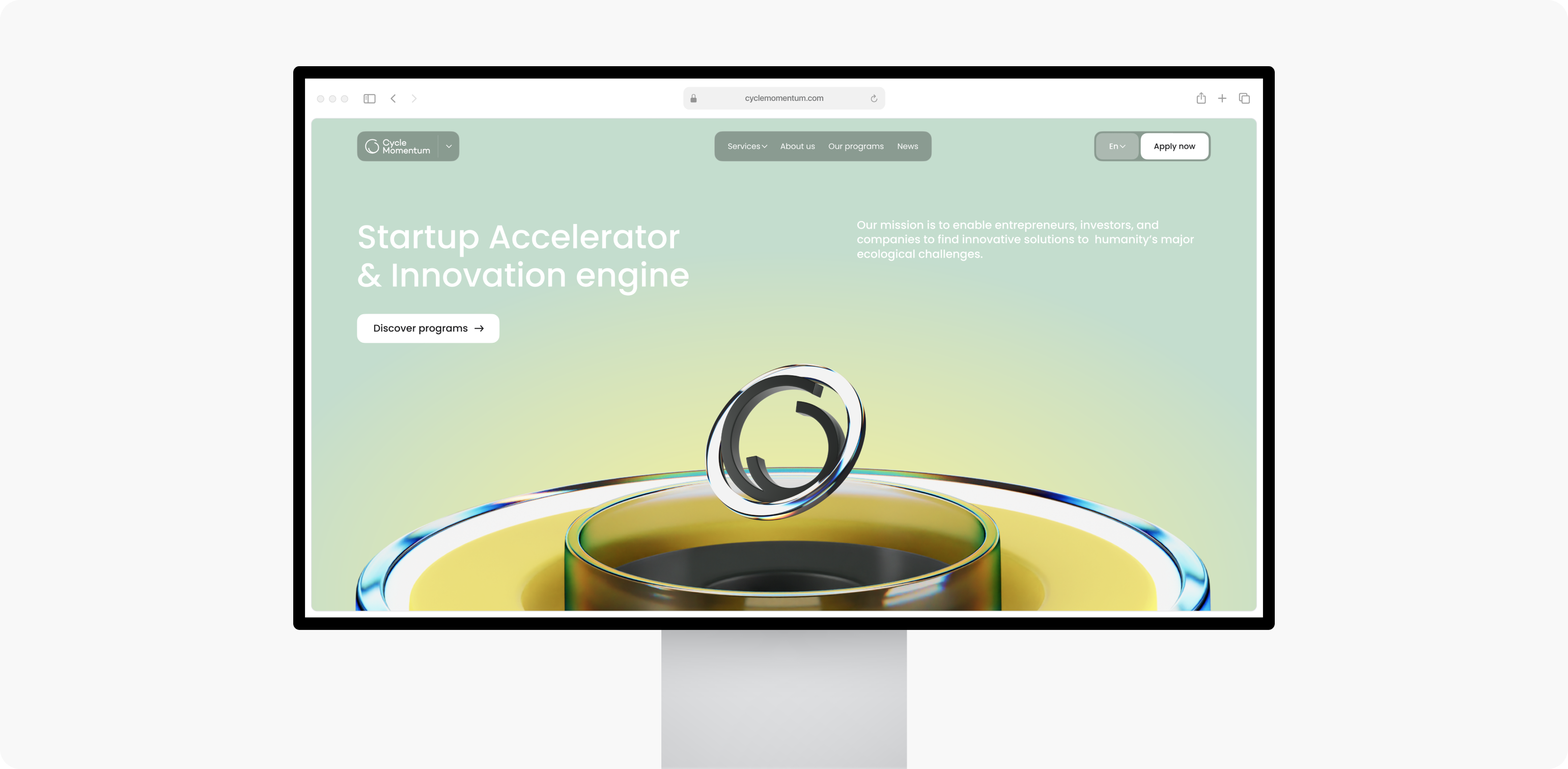 A monitor showcases a startup accelerator website crafted by Webgamma UX Agency, featuring a unique green and yellow liquid-themed design.