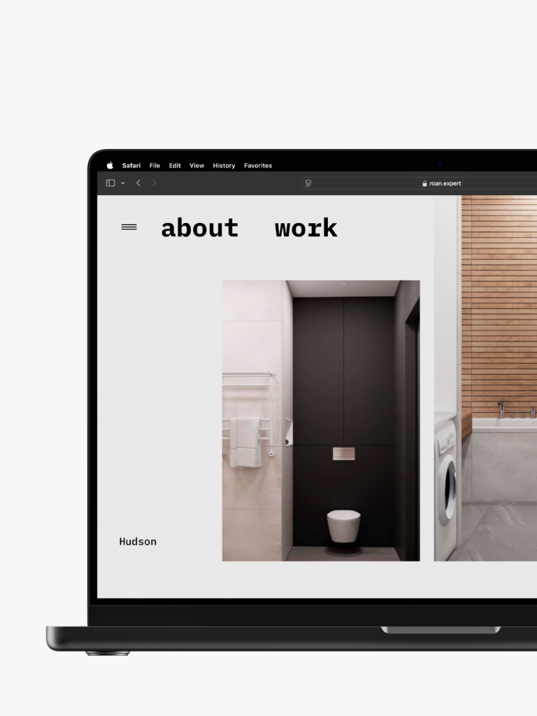 A laptop showcasing a minimalist construction website designed by Webgamma. It highlights sleek bathroom images, with text links. It's a perfect example of cutting-edge website design in Stoney Creek.